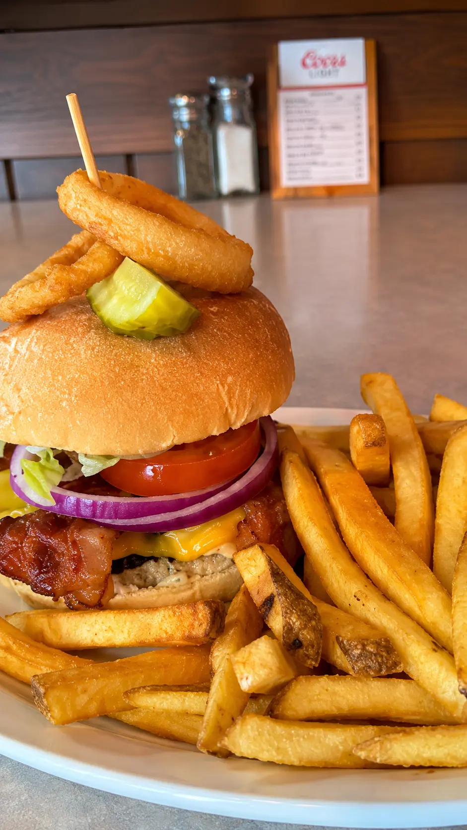 Big Guy Burger — Certified Angus Beef burger with bacon, cheddar and onion rings, served with fries, at Big Guy's Ranch & Saloon, St. Vital, Winnipeg