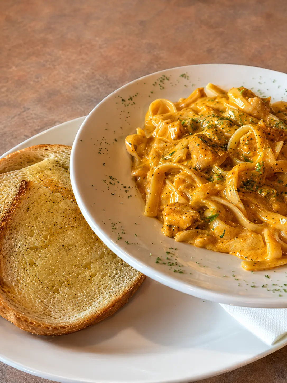Cajun Chicken Fettuccine in a spiced Alfredo sauce with garlic toast at Big Guy's Ranch & Saloon in St. Vital, Winnipeg